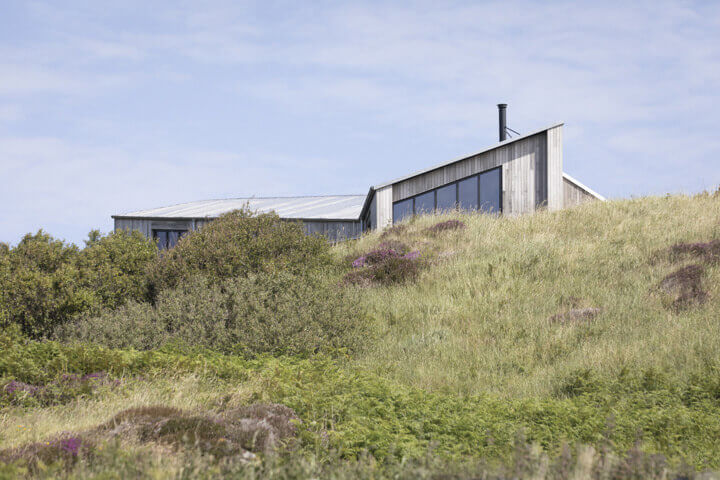 Brimtstone ash cladding on rugged coastal dwelling